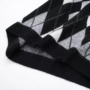 Minimalist argyle knit dress with diamond patterns and ribbed hem in neutral tones