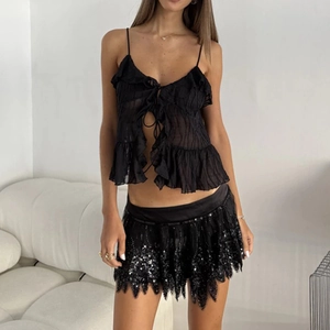 Sexy black two-piece set featuring ruffled halter top and sequined mini skirt on model