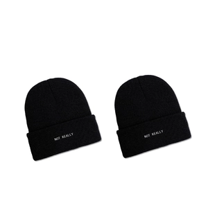 Two-pack of classic black ribbed knit beanies with white NOT REALLY embroidery on the cuff