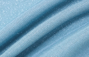 Detailaufnahme von funkelndem eisblauem Netzgewebe mit Glitzer und eleganten Stofffalten