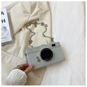 Detailed view of creative camera-shaped bag with silver glitter finish and chain strap
