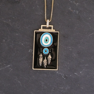 Detail of dreamcatcher pendant with black enamel, blue patterns and three hanging feathers