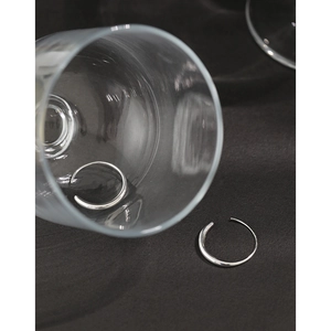 Elegant S925 sterling silver C-shaped hoop earrings displayed on a glass with a dark background