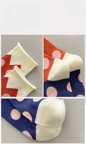 Detail of polka dot combed cotton socks showing elastic cuffs and reinforced heels