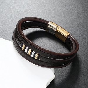 Detail of dark brown leather multi-layer bracelet with gold magnetic clasp on stone