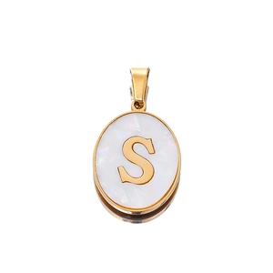 Macro detail of oval 22mm gold letter S pendant with white shell texture inlay