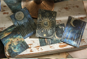 Detail of vintage celestial stickers with gold foil moons and stars for DIY journaling