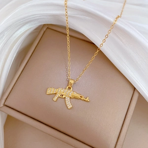 Detailed view of a gold-plated rifle pendant encrusted with sparkling zircon stones