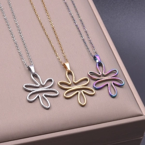 Detailed macro view of gold, silver, and iridescent flower pendants on a jewelry box