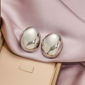 Minimalist silver geometric bean stud earrings in a polished oval pebble shape design