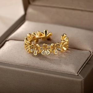Detailed view of gold flower rings with pavé cubic zirconia in a jewelry gift box
