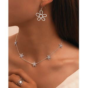 Minimalist silver flower jewelry set with hollow petal necklace, earrings, and open ring