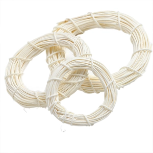 Three cream-colored Indonesian rattan rings for DIY Christmas crafts on white background