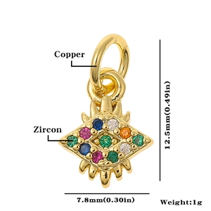 Macro detail of a 12.5mm gold copper eye pendant with colorful zircon inlay