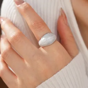 Minimalist wide band ring with grey marble texture and silver metal base on model