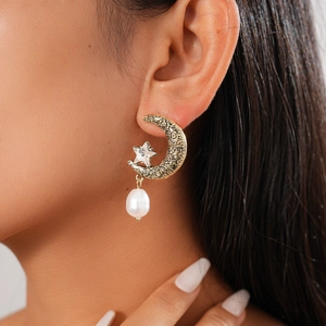 Vintage gold moon and star earrings with rhinestones and white irregular pearls on model