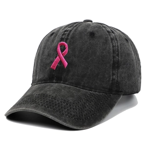 Detailed close-up of pink ribbon embroidery on charcoal grey washed cotton baseball cap