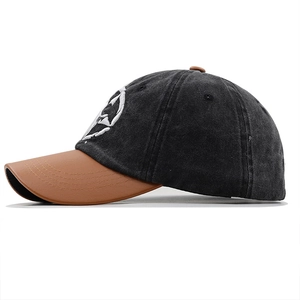 Close-up of vintage washed cotton baseball cap with PU leather brim and star embroidery