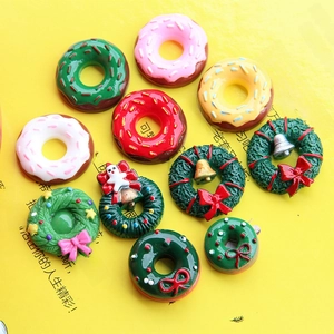 Macro detail of resin Christmas wreaths and colorful donut charms for DIY crafts