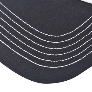 Macro shot of black baseball cap brim with six rows of white contrast stitching detail