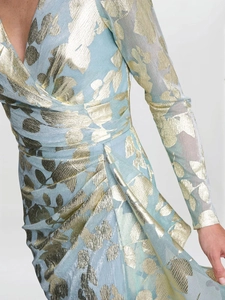 Detail of light blue jacquard dress with gold leaf patterns and pleated waistline