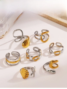 Close-up of seven minimalist two-tone stainless steel rings with sea and chain designs