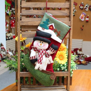 Christmas stocking with 3D snowman and festive tree hanging on a wooden stand