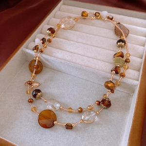 Detail of vintage layered beaded necklace with amber stones and irregular beads