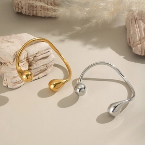 Minimalist geometric open bangle in gold and silver finish with teardrop ends