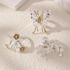 Detailed view of vintage silver ring set with butterfly, flower and dragonfly motifs