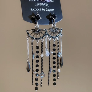 Close-up of 925 silver long tassel earrings with black beads and crystal water drops