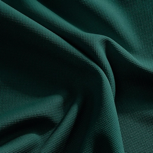 Close-up of dark green quick-dry fabric showing fine breathable mesh texture and drape