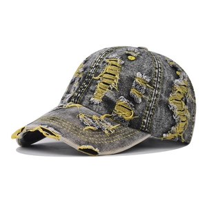 Vintage washed denim baseball cap with distressed rip details and yellow contrast stitching
