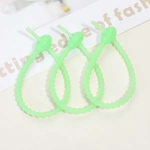 Three neon green silicone cable ties with adjustable loop design on a neutral background