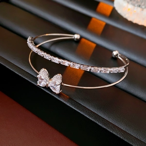 Macro shot of silver bow bracelet with double layers and sparkling white zircons
