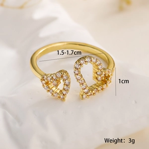 Detailed size view of gold open ring featuring hollow hearts and sparkling zircon stones