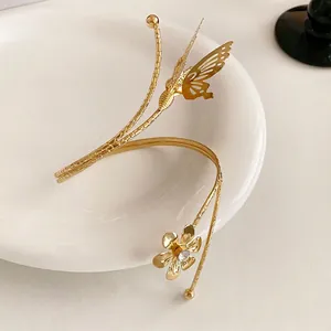 Elegant gold wrap bracelet with butterfly and flower designs featuring sparkling crystals