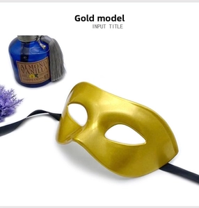 Detail of vintage gold masquerade mask with black ribbons, lavender and scent bottle