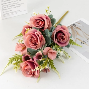 Detailed view of vintage dusty rose artificial bouquets with lush petals and leaves