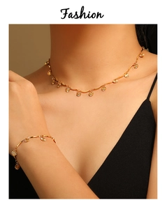 Detail of golden sunflower petal necklace and bracelet set on model with wavy chain
