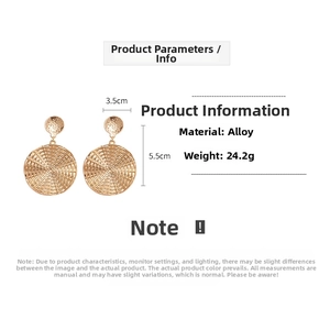 Detail view of gold alloy geometric earrings with spiral texture and 3.5cm width