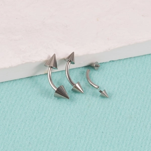 Detailed view of G23 titanium curved barbells with threaded cone ends for body piercing