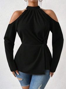 Detail of black cold shoulder top featuring a stylish front twist knot and long sleeves