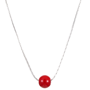 Detailed view of silver snake chain necklace featuring a vibrant red round bead pendant