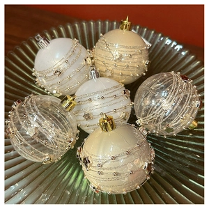Detail of elegant champagne and white Christmas tree ball ornaments with glitter stars