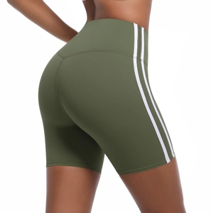 Detail view of high-waisted olive green yoga shorts with white side stripes and slim fit