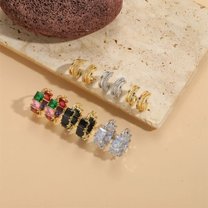 Square zircon hoop earrings in various colors displayed on a beige stone surface