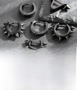 Detail view of 8mm black titanium steel hoop earrings with spiked punk designs and patterns