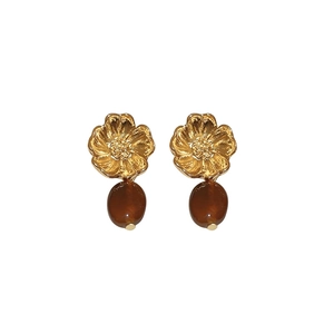 Vintage gold flower earrings with amber resin water drop pendants on white background