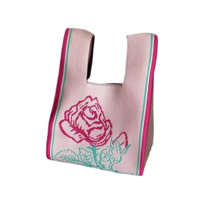 Retro pink knitted tote bag with large rose floral pattern and woven top handles